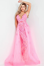 Model wearing Jovani 62929, a pink gown with floral appliqués and a tulle overlay.