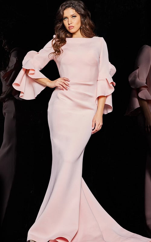 Model wearing Jovani 63168 blush dress with mermaid silhouette and tiered bell sleeves.