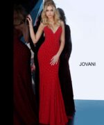Model wearing Jovani 63563 red dress with V-neckline and sparkle, front view.