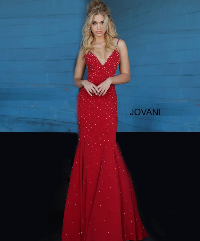 Model wearing Jovani 63563 red dress with mermaid silhouette and embellishments, front view.