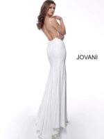 Model wearing Jovani 63563 white dress showcasing the low back design, back view.