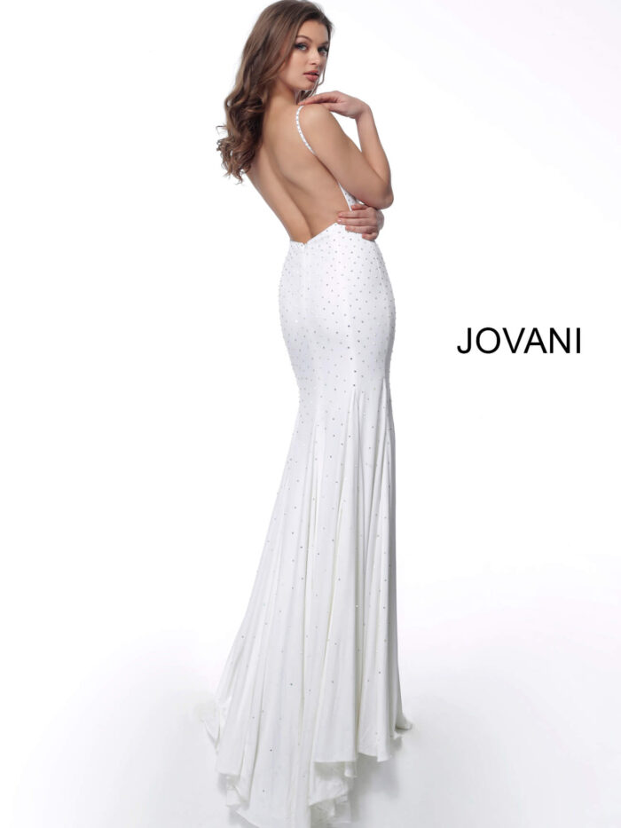 Model wearing Jovani 63563 white dress showcasing the low back design, back view.