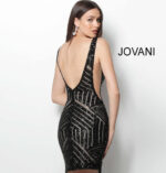 Model wearing Jovani 63899 black sequin mini dress, back view.