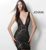 Model wearing Jovani 63899 black sequin mini dress, front view.