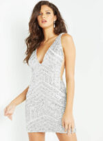 Model wearing Jovani 63899 white sequin mini dress, front view.