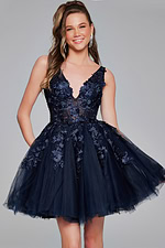 Model in navy Jovani 63987 dress with floral applique.