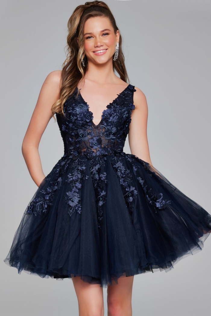 Model in navy Jovani 63987 dress with floral applique.