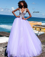 Model in Jovani 65379 lilac ballgown featuring a sparkling bodice against a seaside backdrop.