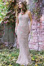 Model wearing Jovani 99700, a nude strapless beaded gown, front view.