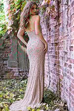 Model showing back view of Jovani 99700, a nude strapless beaded gown.