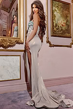 model showcasing the back of D5076 gold dress with high slit detail
