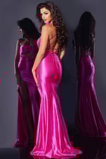 Model back view wearing Jovani D5807 fuchsia gown with lace-up detail.