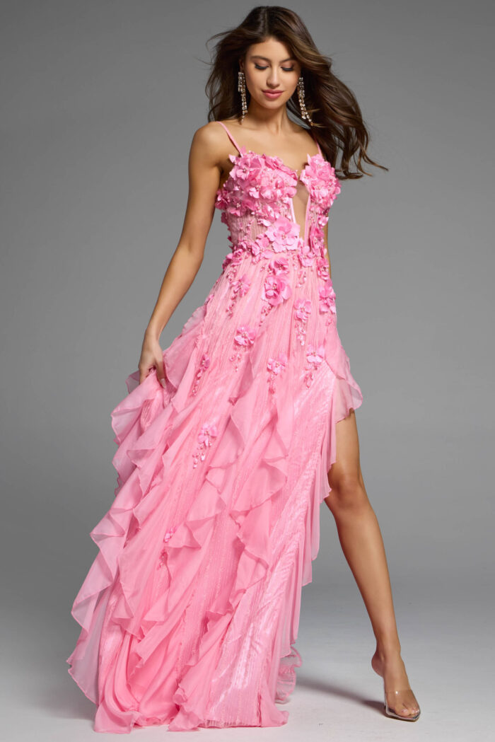 Front view of a ruffled pink evening gown with floral applique and a thigh-high slit.