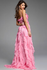 Back view of a pink gown with a flowing ruffled skirt and floral embellishments.