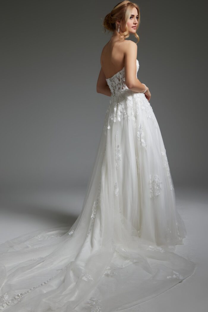 Side-back view of Jovani JB05361 in ivory, highlighting the intricate lace detailing and full skirt.
