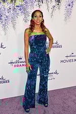 Model wearing Jovani 61740 teal blue velvet jumpsuit with strapless neckline and wide-leg pants.