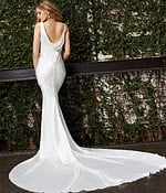 Model wearing Jovani JB03910 white dress with mermaid silhouette, back view with buttons.