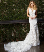 Model wearing Jovani JB04192 white gown that elegantly flows to the ground