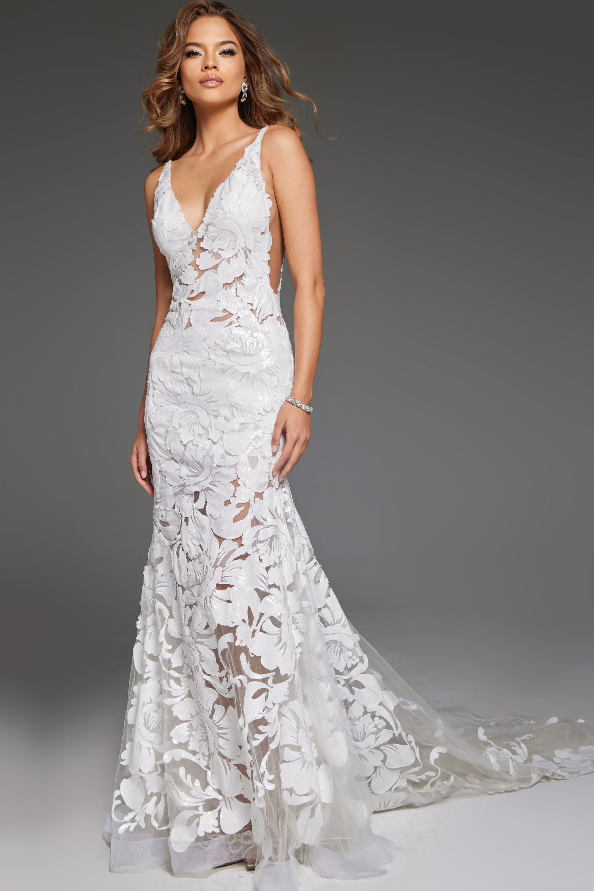 JB04192 Model wearing Jovani JB04192 white gown with V-neckline and floral appliqué from front view