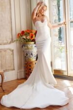 Jovani JB04879 white gown with sweetheart neckline and flowing train.