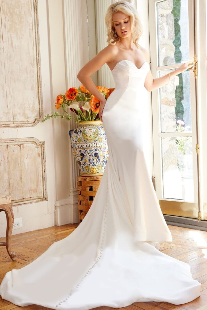 Model in Jovani JB04879 white dress front view showing fitted silhouette.