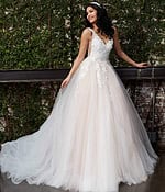 Model wearing Jovani JB05353 white gown with V-neckline and lace appliques
