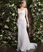 Model posing in Jovani JB06666 white dress with intricate beadwork, front view