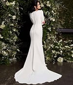 Model showing the back of Jovani JB06911 ivory gown with covered button detail.