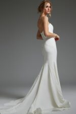 Back view of model wearing Jovani JB06912 ivory gown with button detailing.