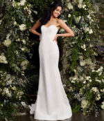 Model in Jovani JB06912 ivory gown in garden setting.