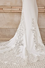 Model wearing Jovani JB06928 showcasing the ivory lace train.