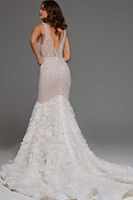 Model in Jovani JB07233 white dress, showing deep V-back and textured applique train, back view.