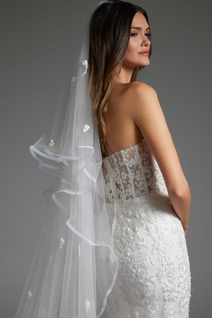 Model wearing Jovani JB07260 white mermaid gown with detailed back view and train.