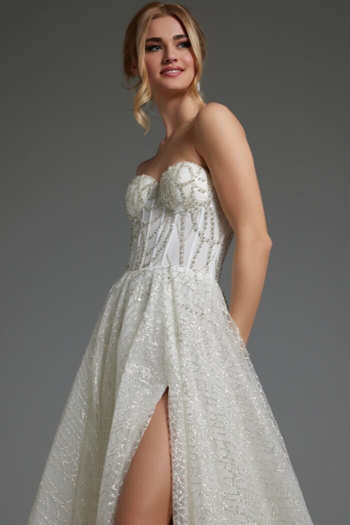 Model posing in JB07578 ivory gown with sweetheart neckline and high slit.