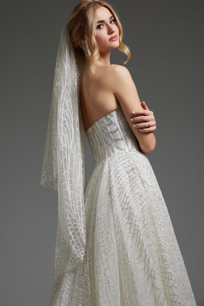 Back view of model wearing JB07578 ivory gown with lace details.