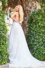 Back view of model in Jovani JB07646 ivory gown with open back design