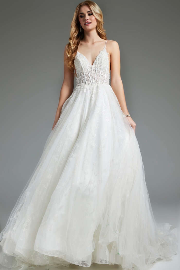 Model wearing flowing ivory Jovani JB07647 dress with lace details.