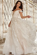 Model displaying JB220001 ivory gown with flowing skirt and lace embroidery.