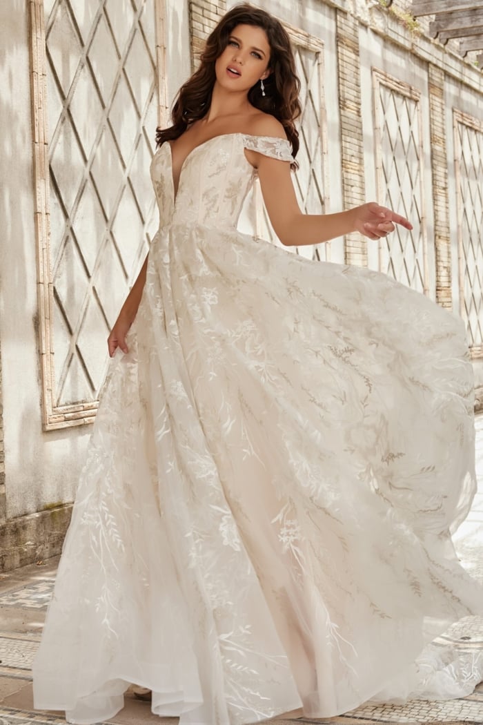 Model displaying JB220001 ivory gown with flowing skirt and lace embroidery.