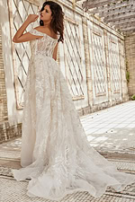 Model showcasing the back of JB220001 ivory gown with lace detailing and corset back.