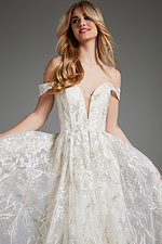 Model in JB220001 gown with detailed lace work on the ivory fabric.