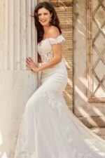 Model wearing Jovani JB220003 ivory gown with lace bodice and tulle skirt.