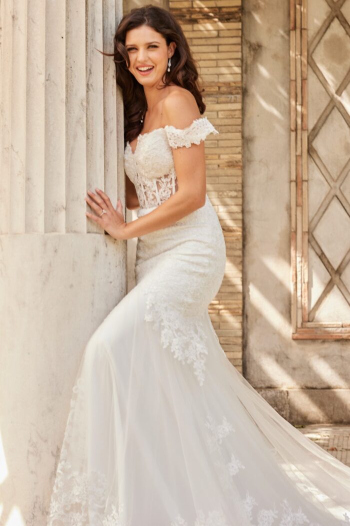 Model wearing Jovani JB220003 ivory gown with lace bodice and tulle skirt.
