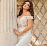 Side view of Jovani JB220003 ivory gown with off-the-shoulder neckline.