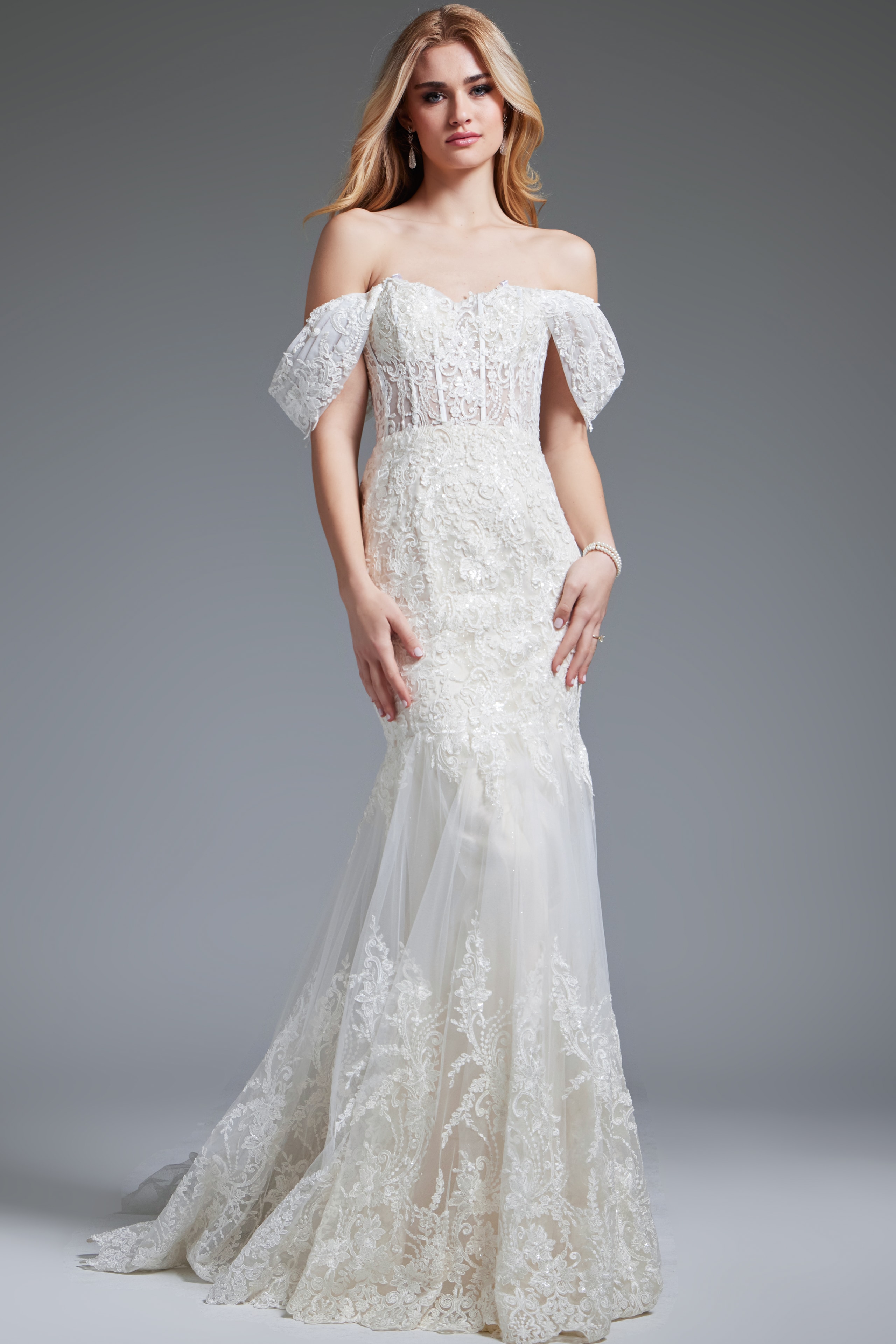 JB220003-IVORY-202.jpg Model wearing Jovani JB220003 ivory gown with off-the-shoulder neckline, full length.