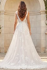 Back view of a lace A-line bridal gown with V-back, floral appliqués, and soft tulle train.