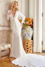 Full view of Jovani JB23181 white gown featuring deep V-neck and long sleeves