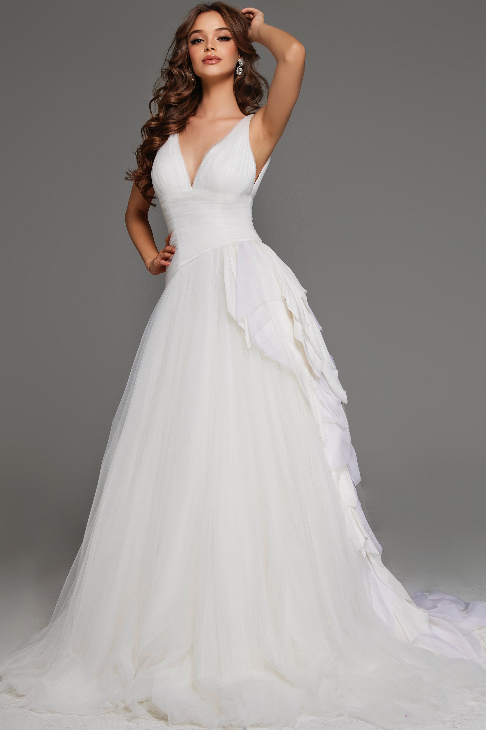 JB23241-9 Model wearing Jovani JB23241 white A-line gown with deep V-neck and cascading ruffles.