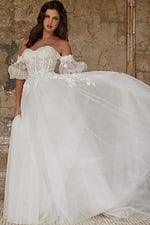 Model wearing Jovani JB23693 white gown with floral lace and puff sleeves, graceful pose front view.