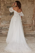 Model wearing Jovani JB23693 white gown, back view with flowing train.
